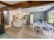 Bright kitchen with white cabinetry, granite countertops, stainless steel appliances, and adjacent dining area at 8742 Rittenhouse Cir, Charlotte, NC 28270