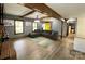 Open living room with wooden beams, hardwood floors, fireplace, and a yellow front door at 8742 Rittenhouse Cir, Charlotte, NC 28270