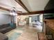 Open-concept living room with hardwood floors, brick fireplace, and seamless flow to the kitchen and dining area at 8742 Rittenhouse Cir, Charlotte, NC 28270