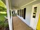 Inviting front porch with painted columns, black shutters, and ample space for outdoor seating at 8742 Rittenhouse Cir, Charlotte, NC 28270