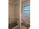 Bathroom with blue wallpaper, shower, toilet, and shelves at 9225 Robinson Church Rd, Charlotte, NC 28215