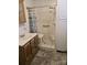 Functional bathroom featuring a shower with accessibility seating, vanity, and tiled floor at 9225 Robinson Church Rd, Charlotte, NC 28215