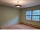 This bedroom features a window view and unique lighting fixture at 9225 Robinson Church Rd, Charlotte, NC 28215