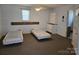 Spacious bedroom with twin beds, built-in storage, a ceiling fan and neutral decor at 9225 Robinson Church Rd, Charlotte, NC 28215