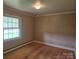 This bedroom features a large window view and carpeting at 9225 Robinson Church Rd, Charlotte, NC 28215