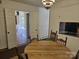 Cozy dining area featuring a round wooden table, traditional light fixture and ample natural light at 9225 Robinson Church Rd, Charlotte, NC 28215