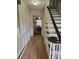 Bright entryway featuring laminate flooring, a staircase, white wainscoting and access to other rooms at 9225 Robinson Church Rd, Charlotte, NC 28215