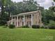 Two-story brick house with columns, red shutters, chimney, and a large lawn at 9225 Robinson Church Rd, Charlotte, NC 28215