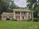 Beautiful two-story brick house with a porch, pillars, red shutters, and a large grassy front yard at 9225 Robinson Church Rd, Charlotte, NC 28215