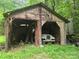 Exterior view of a wooden garage and vehicle at 9225 Robinson Church Rd, Charlotte, NC 28215