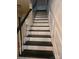 View of a staircase with dark treads and white risers, and a white paneled wall at 9225 Robinson Church Rd, Charlotte, NC 28215