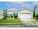 Charming single-story home with attached garage, vibrant turquoise shutters, and well-maintained lawn at 9623 Duxford Ln, Charlotte, NC 28269