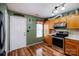 Well-lit kitchen with stainless steel appliances, wood cabinets, and vinyl flooring at 9623 Duxford Ln, Charlotte, NC 28269