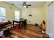 Versatile room with hardwood floors, bright lighting, and a ceiling fan at 9623 Duxford Ln, Charlotte, NC 28269