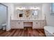 Bathroom vanity with dual sinks, decorative mirrors, lighting sconces, and wood-look flooring at 0000 Trull Hinson Rd # 2, Wingate, NC 28174