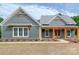Charming exterior with a covered front porch, wood accents, and professionally landscaped yard at 0000 Trull Hinson Rd # 2, Wingate, NC 28174