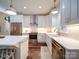 Well-lit kitchen with stainless steel appliances, white cabinets, quartz countertops, and farmhouse sink at 0000 Trull Hinson Rd # 2, Wingate, NC 28174