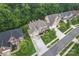 Aerial view of home featuring mature trees, manicured lawn, three car garage, and long driveway at 10620 Euclid Nw Ave, Concord, NC 28027