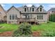Beautiful backyard view showcasing a deck, lush lawn, mature trees, and well-maintained landscaping at 10620 Euclid Nw Ave, Concord, NC 28027