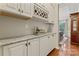 Butler's pantry features modern white cabinets, granite countertops, and a wine rack at 10620 Euclid Nw Ave, Concord, NC 28027