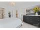 Bright bedroom features white walls, a decorative chandelier, and a black dresser with modern artwork at 10620 Euclid Nw Ave, Concord, NC 28027