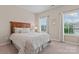 Cozy bedroom with neutral walls, plush carpet, and bright windows with lovely light at 10620 Euclid Nw Ave, Concord, NC 28027