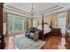 Spacious primary bedroom featuring a canopy bed, chandelier lighting, and hardwood floors at 10620 Euclid Nw Ave, Concord, NC 28027