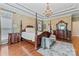 Elegant primary bedroom with a canopy bed, a stylish rug, and sophisticated decor at 10620 Euclid Nw Ave, Concord, NC 28027