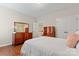 Bedroom with hardwood floors, white bedding, wood furniture, and neutral colored walls at 10620 Euclid Nw Ave, Concord, NC 28027