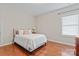Simple bedroom with hardwood flooring, plush bedding, and natural light from the window at 10620 Euclid Nw Ave, Concord, NC 28027