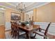 Formal dining room featuring a large wooden table, chandelier, and elegant decor at 10620 Euclid Nw Ave, Concord, NC 28027