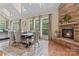 Dining room with stone fireplace, skylights, and large windows providing natural light at 10620 Euclid Nw Ave, Concord, NC 28027