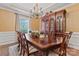 Elegant dining room with a large wooden table, ornate china cabinet, and chandelier at 10620 Euclid Nw Ave, Concord, NC 28027