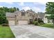 Charming brick home boasts a well-manicured lawn, lush landscaping, and a spacious three-car garage at 10620 Euclid Nw Ave, Concord, NC 28027
