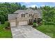 Stunning brick home featuring a three-car garage, beautiful stone accents, and well-manicured landscaping at 10620 Euclid Nw Ave, Concord, NC 28027