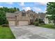 Elegant brick home featuring a spacious driveway, three-car garage, and meticulously landscaped front yard at 10620 Euclid Nw Ave, Concord, NC 28027