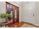 Bright foyer with hardwood floors, glass-paneled doors, and neutral wall colors at 10620 Euclid Nw Ave, Concord, NC 28027