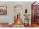 Elegant foyer with hardwood floors, arched doorways, and a view of the staircase at 10620 Euclid Nw Ave, Concord, NC 28027