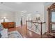 Bright hallway features hardwood floors, wooden railings, and decorative light fixtures at 10620 Euclid Nw Ave, Concord, NC 28027