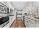 Modern kitchen featuring stainless steel appliances, granite countertops, and beautiful hardwood floors at 10620 Euclid Nw Ave, Concord, NC 28027