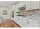 Kitchen area showcasing white cabinets, granite counters, and stainless steel appliances at 10620 Euclid Nw Ave, Concord, NC 28027