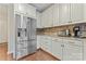 Close up of kitchen with stainless steel refrigerator and white cabinets at 10620 Euclid Nw Ave, Concord, NC 28027