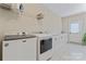 Well-equipped laundry room with modern appliances, countertop space, and ample storage at 10620 Euclid Nw Ave, Concord, NC 28027