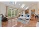 Bright living room with skylights, a stone fireplace, and views of the outdoor scenery at 10620 Euclid Nw Ave, Concord, NC 28027