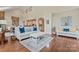 Open-concept living room with a fireplace, dining area, and kitchen in the background at 10620 Euclid Nw Ave, Concord, NC 28027