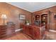 Sophisticated home office featuring a large wooden desk, built-in bookcase, and hardwood floors at 10620 Euclid Nw Ave, Concord, NC 28027