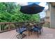 Outdoor patio features a dining table set under a patio umbrella, surrounded by lush greenery at 10620 Euclid Nw Ave, Concord, NC 28027