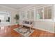 Inviting sitting area with hardwood floors, white shutters, and a plush pink bench at 10620 Euclid Nw Ave, Concord, NC 28027