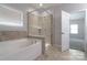 Luxurious bathroom featuring a soaking tub and separate glass shower at 11109 Pond Valley Ct, Charlotte, NC 28269