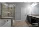 Elegant bathroom with a soaking tub and glass-enclosed shower at 11109 Pond Valley Ct, Charlotte, NC 28269